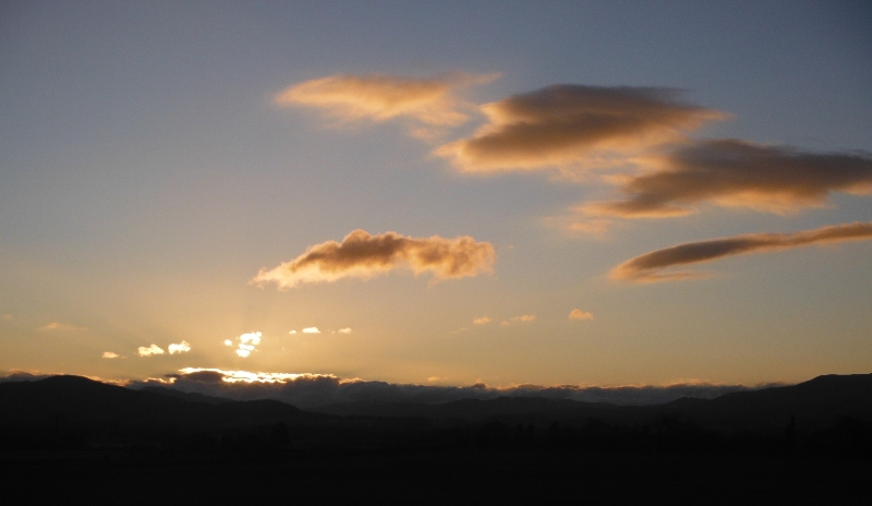  the setting sun lighting up the clouds 