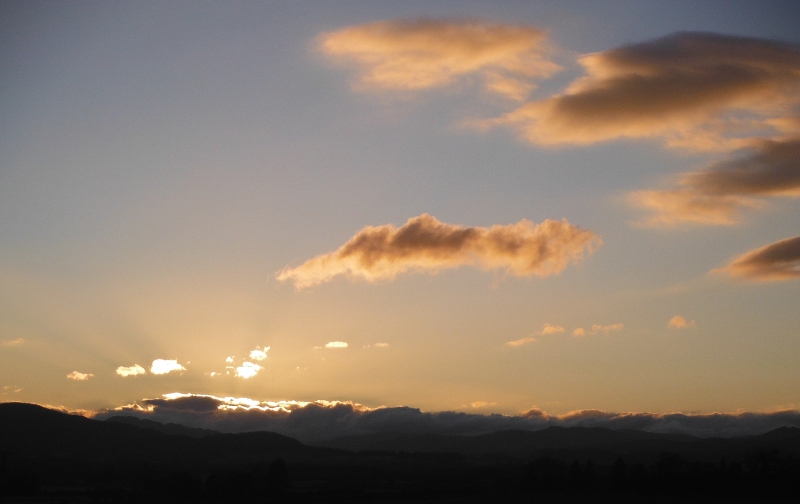  the setting sun lighting up the clouds 