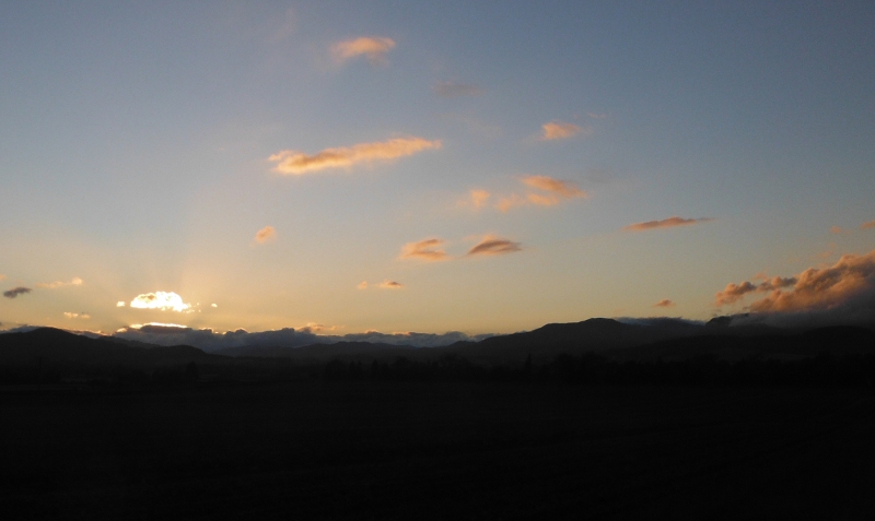  the setting sun lighting up the clouds 