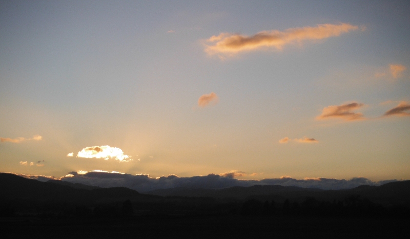  the setting sun lighting up the clouds 