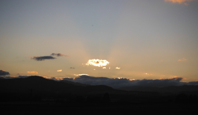  the setting sun lighting up the clouds 