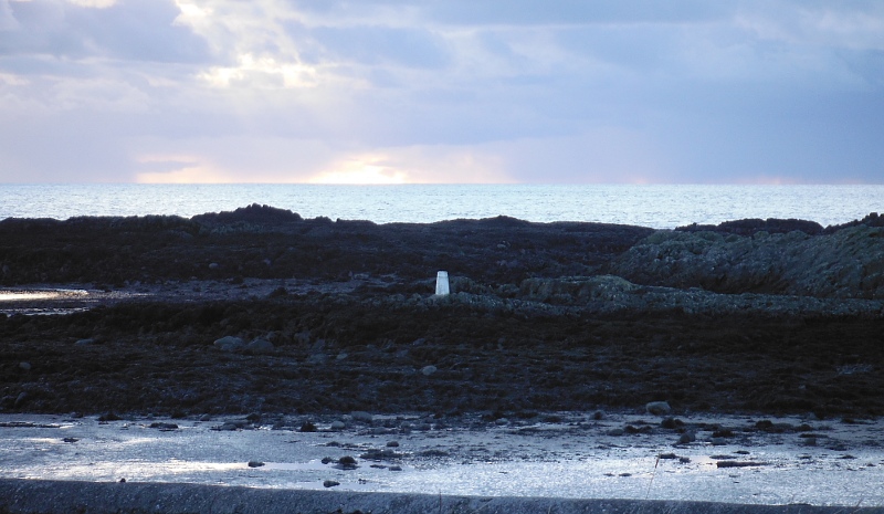  the trig point on the rocks on the high tide line 