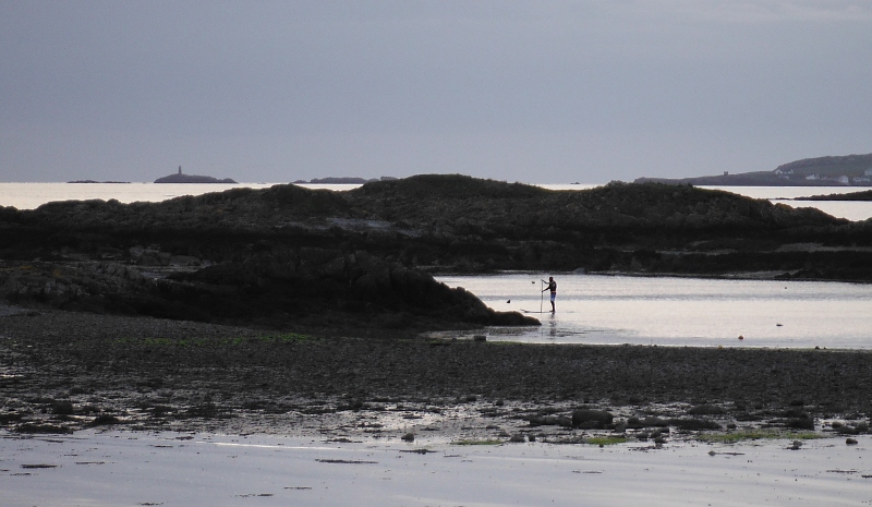  someone on a stand-up paddle board 