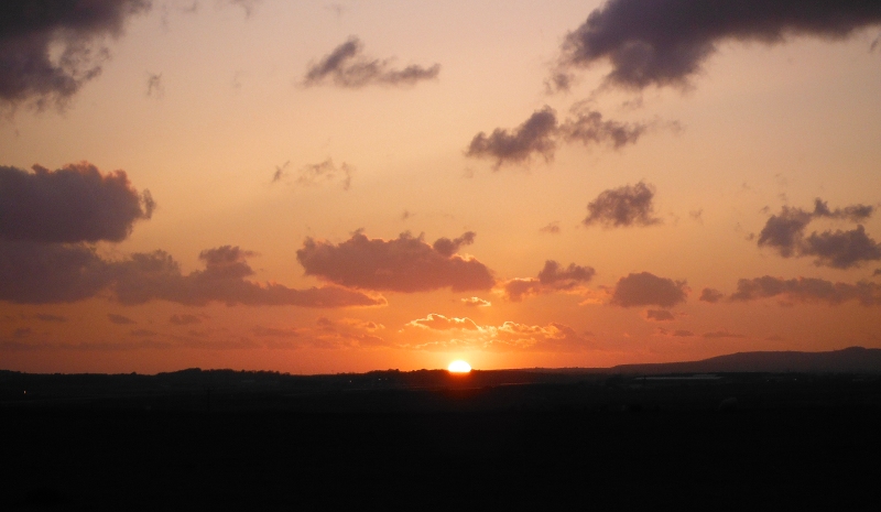  the sun setting below the horizon 