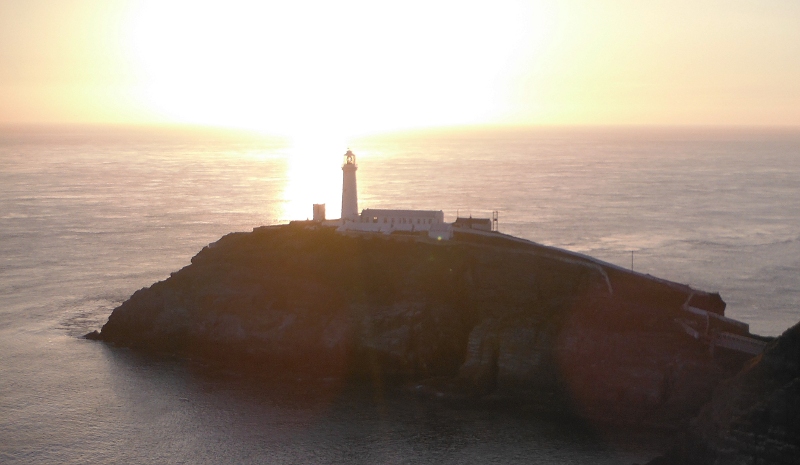  the sun low behind South Stack lighthouse 