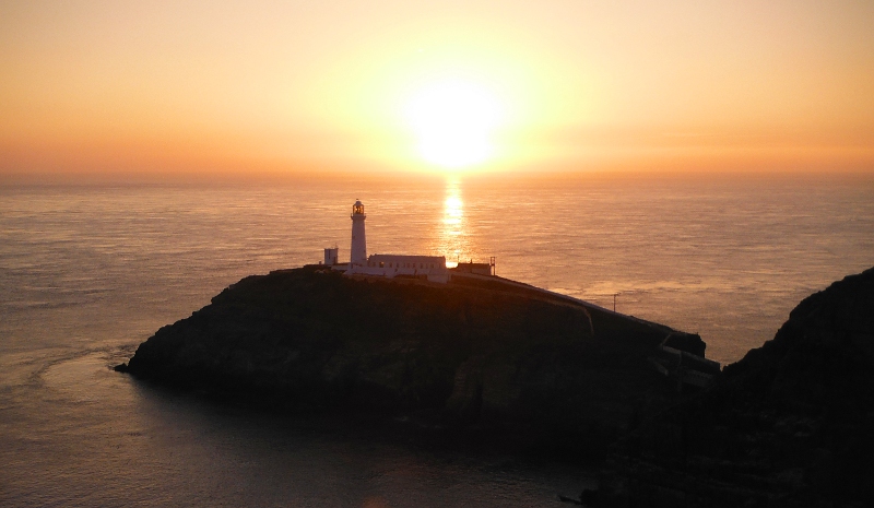  the sun low behind South Stack lighthouse 