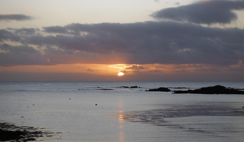  the sun disappearing behind the cloud 