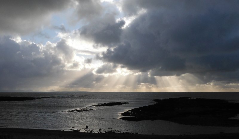  the shafts of sunlight through the clouds 