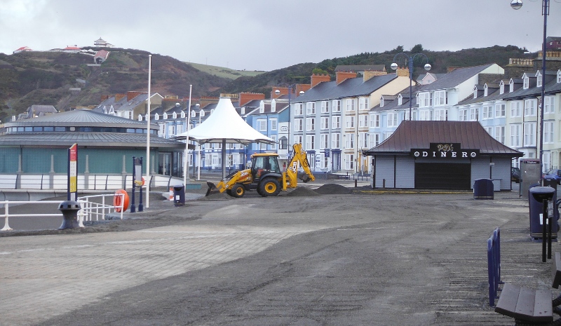  the digger scooping up the shingle 