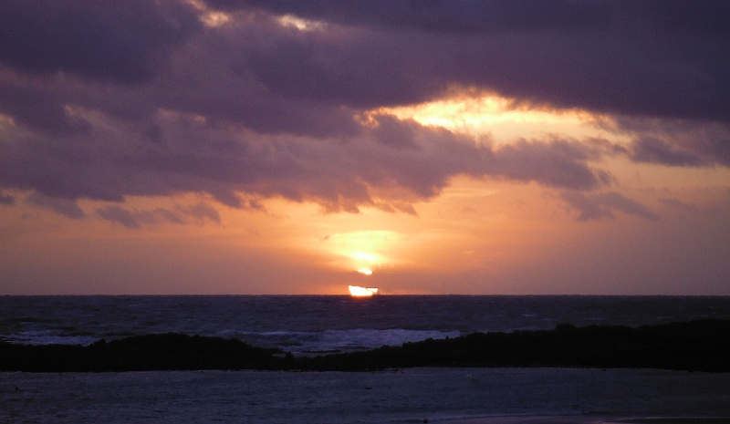  the sun as it starts to drop below the horizon 