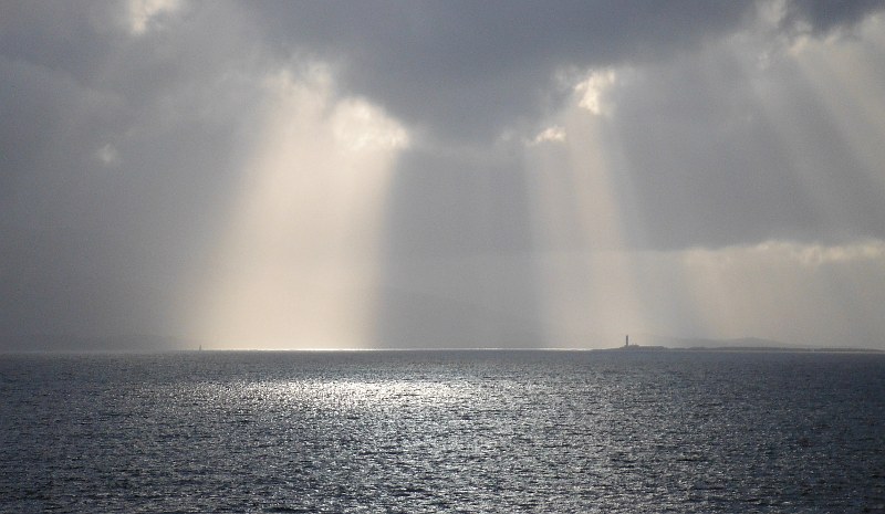  the shafts of sunlight highlighting the two lighthouses 