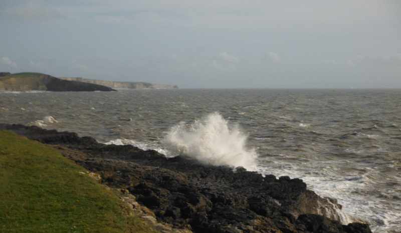  the waves blasting onto the rocks 