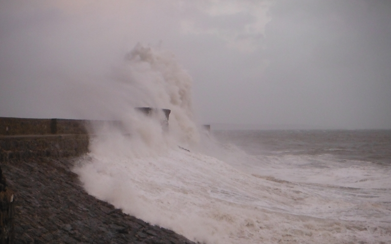  the waves crashing against the pier 