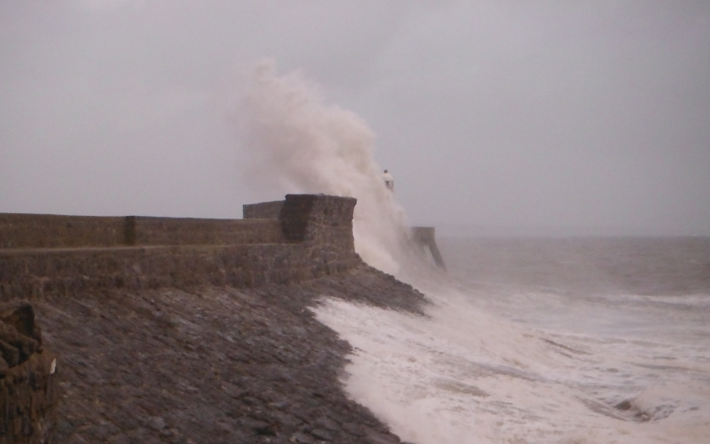  the waves crashing against the pier 