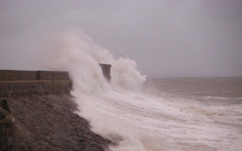  the waves crashing against the pier 