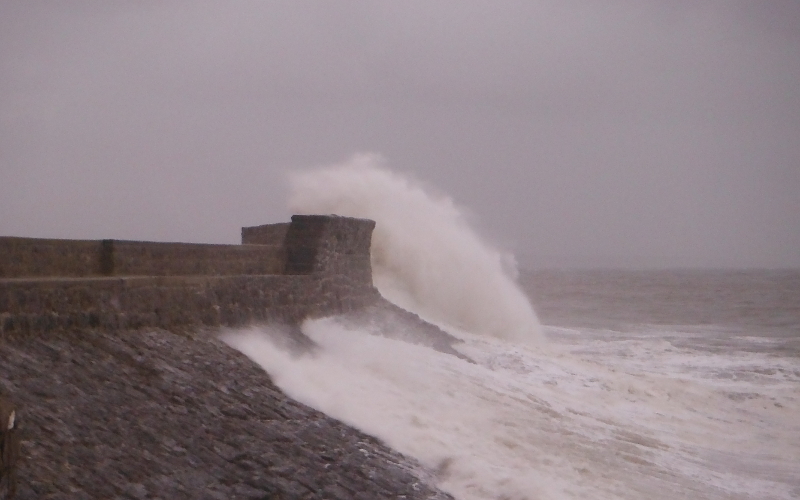  the waves crashing against the pier 