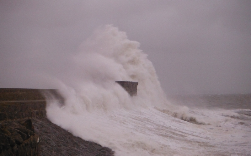  the waves crashing against the pier 