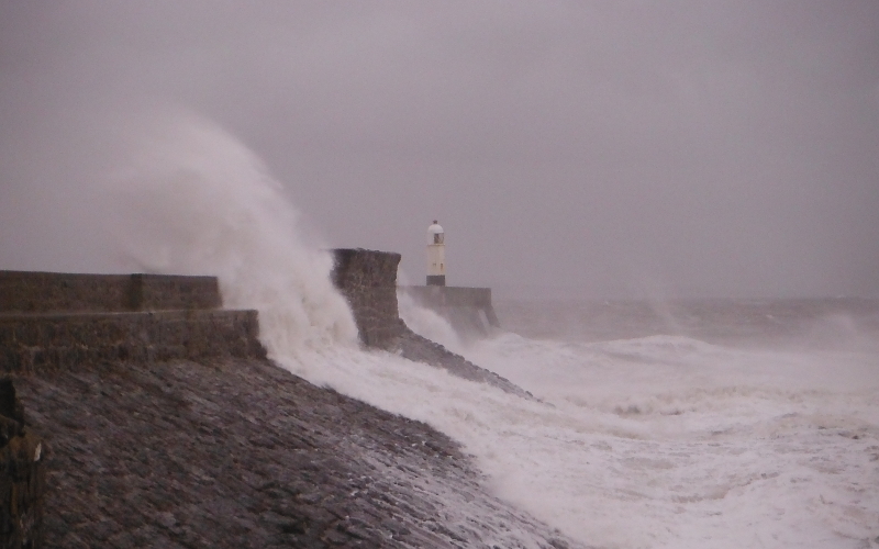  the waves crashing against the pier 