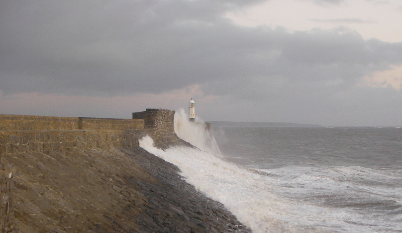  the waves crashing against the pier 