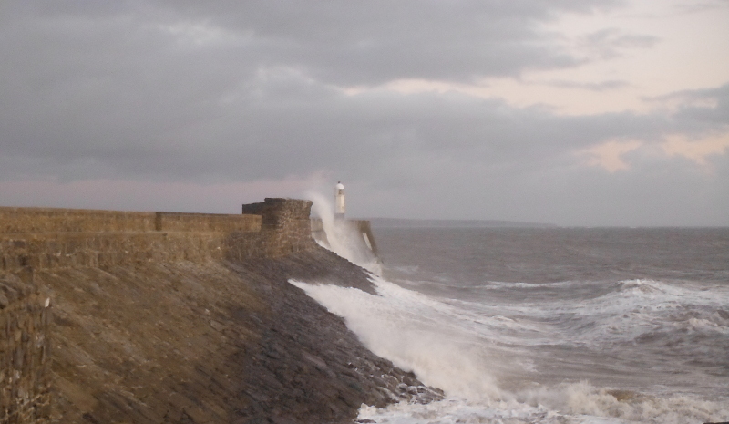  the waves crashing against the pier 